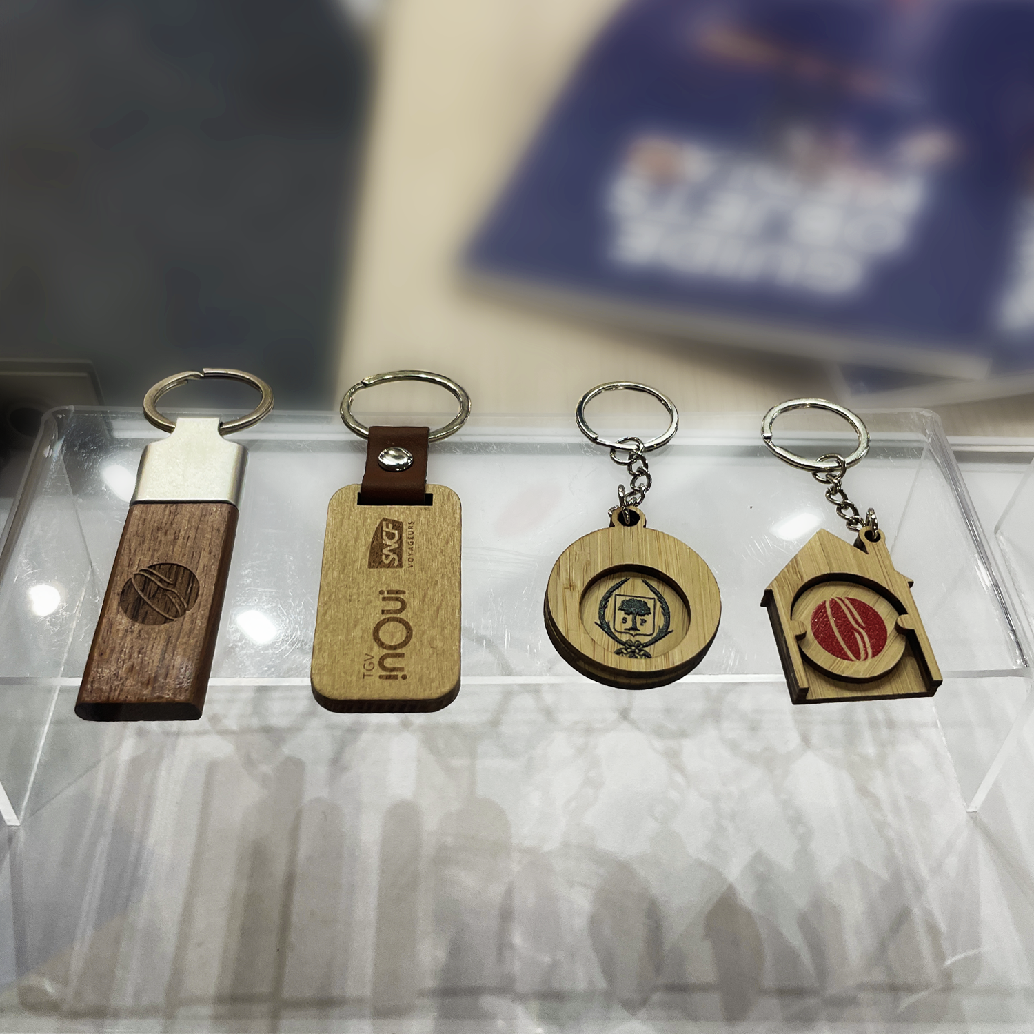 Porte-clés en bois gravés au laser CO₂ avec formes variées et design personnalisé.